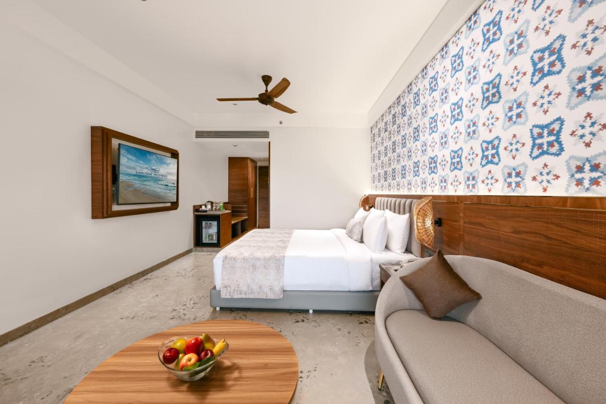 a hotel room with a bed and a bowl of fruit on a table at Gateway Goa, Palolem in Palolem