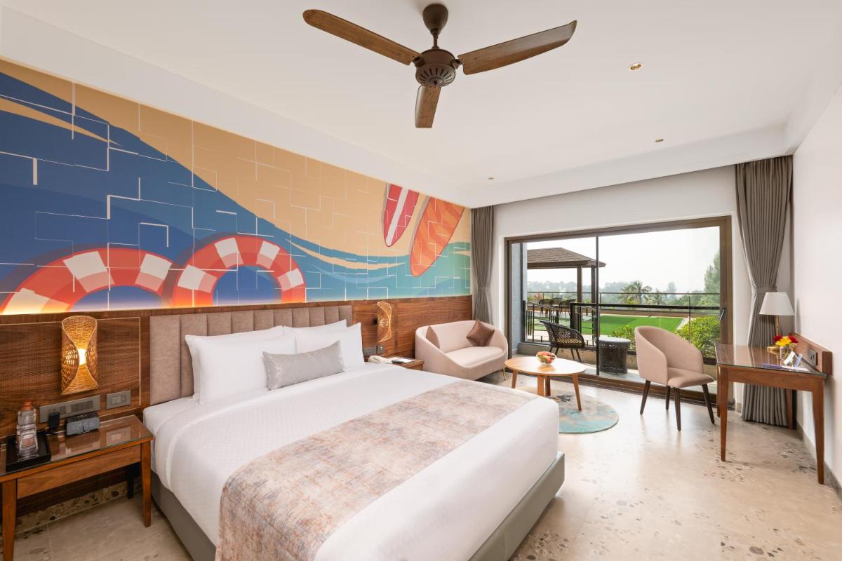 a bedroom with a king sized bed and a mural at Gateway Goa, Palolem in Palolem +90 photos