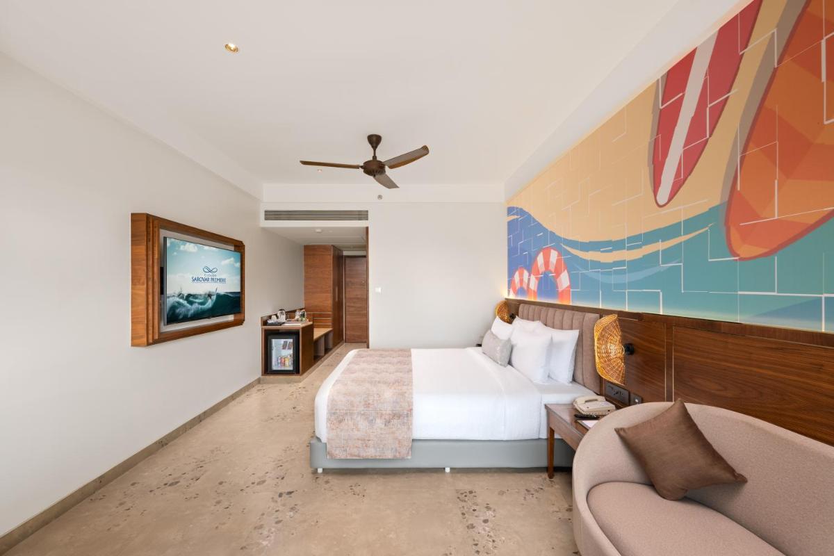 a hotel room with a bed and a couch at Gateway Goa, Palolem in Palolem