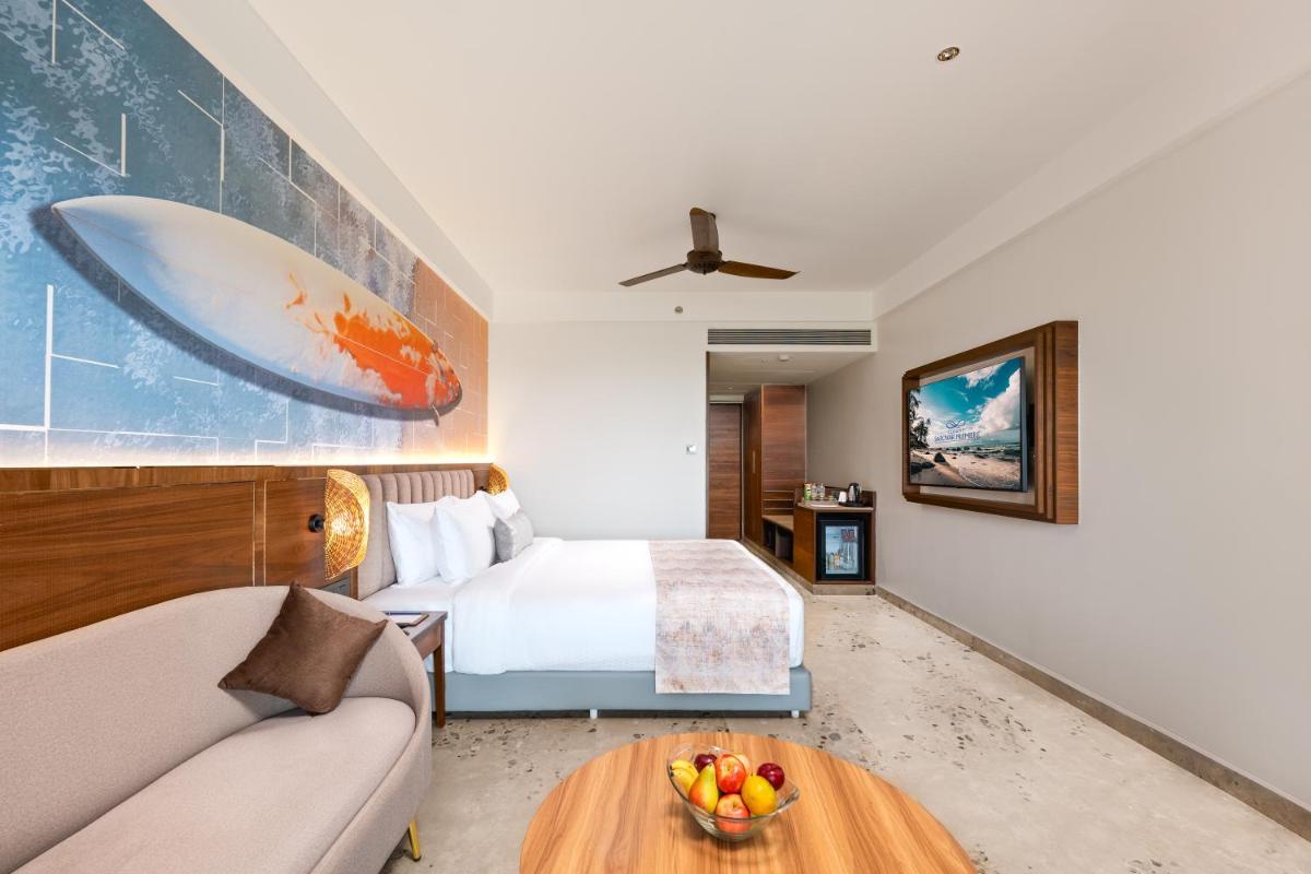a hotel room with a bed and a table at Gateway Goa, Palolem in Palolem