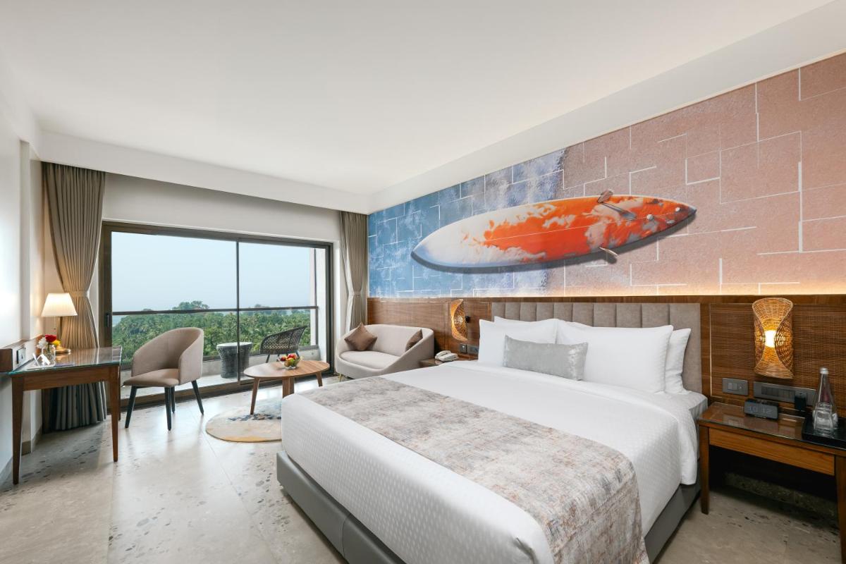 a bedroom with a large bed and a large painting of a fish at Gateway Goa, Palolem in Palolem