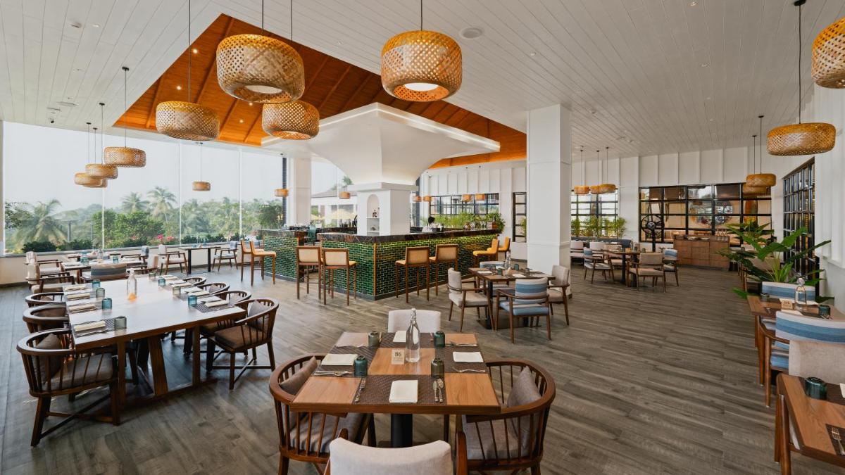 a restaurant with tables and chairs and a bar at Gateway Goa, Palolem in Palolem