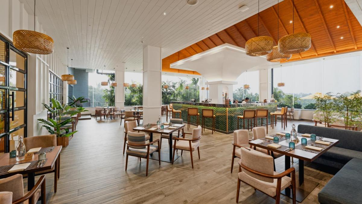 a restaurant with tables and chairs and a bar at Gateway Goa, Palolem in Palolem