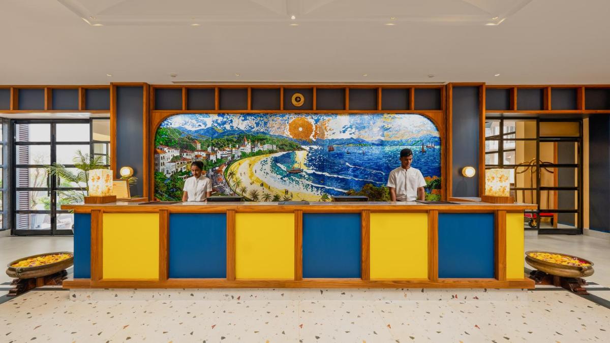 a colorful counter in a restaurant with a painting on the wall at Gateway Goa, Palolem in Palolem