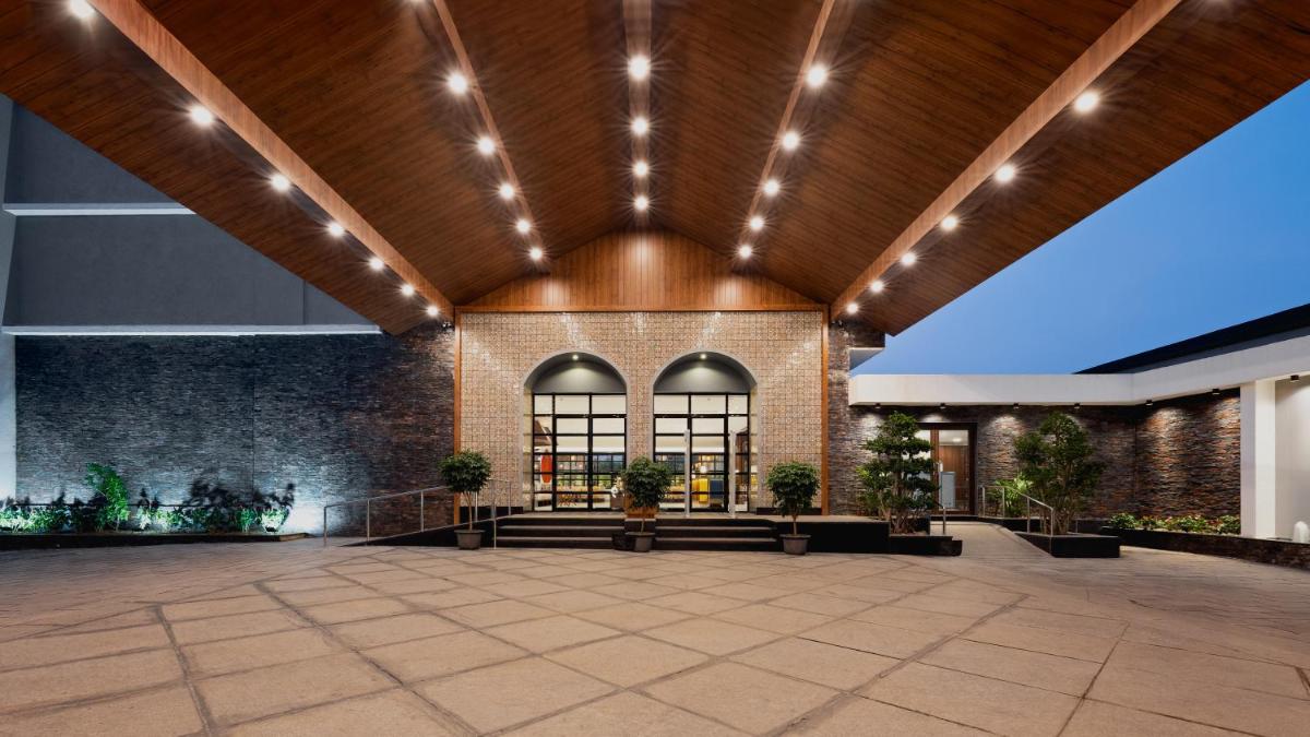 an empty lobby of a building with a wooden ceiling at Gateway Goa, Palolem in Palolem