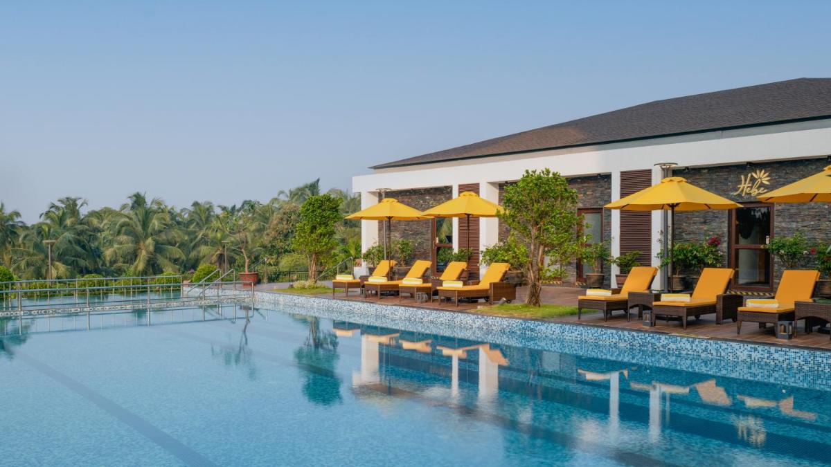 a resort with a swimming pool with chairs and umbrellas at Gateway Goa, Palolem in Palolem