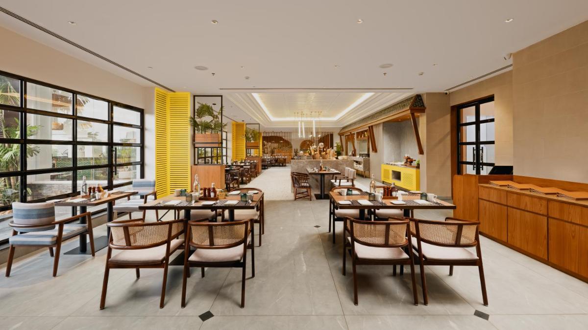 a dining room with tables and chairs in a restaurant at Gateway Goa, Palolem in Palolem