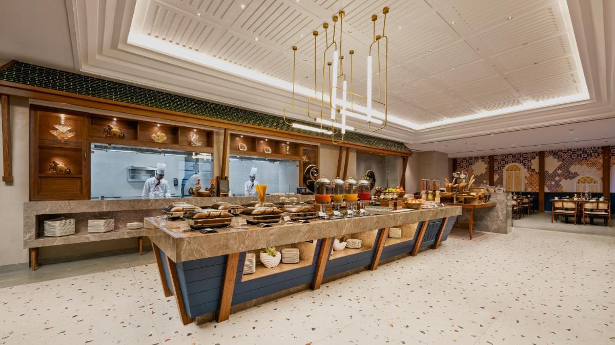 a buffet in a restaurant with food on display at Gateway Goa, Palolem in Palolem