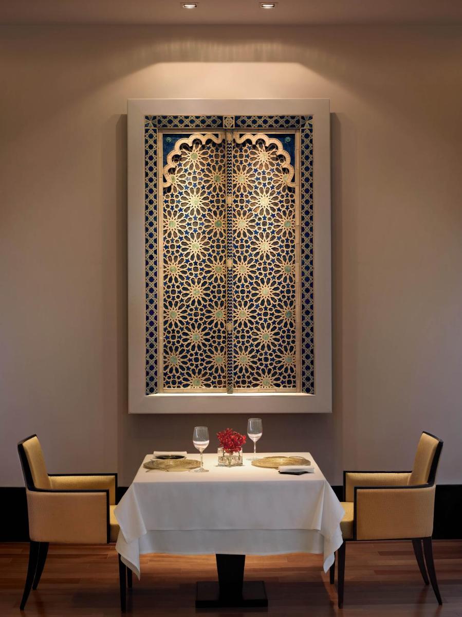 a dining room with a table and a window at The Oberoi Mumbai in Mumbai