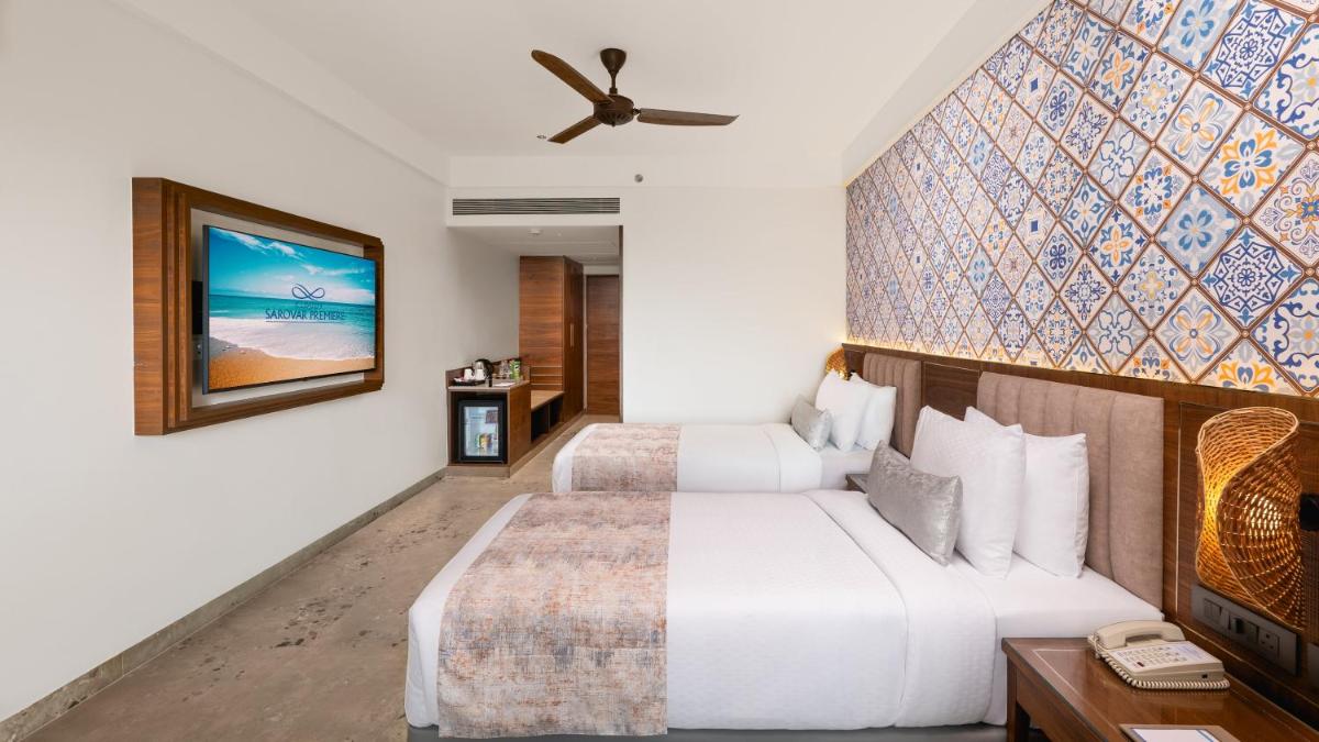 a hotel room with two beds and a ceiling fan at Gateway Goa, Palolem in Palolem