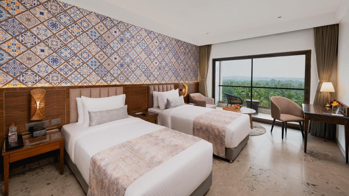 a hotel room with two beds and a desk at Gateway Goa, Palolem in Palolem