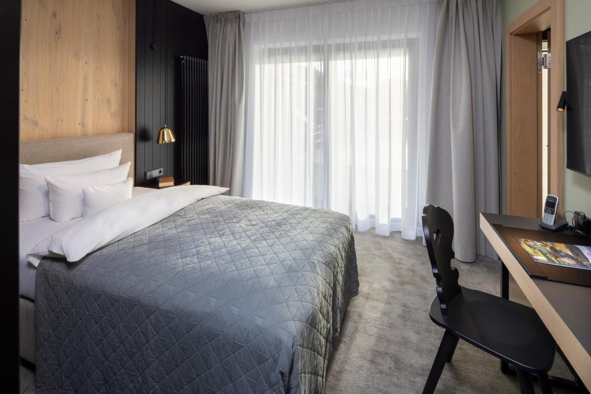 Ein Bett oder Betten in einem Zimmer der Unterkunft Wellness & Genuss Resort - Engel Obertal