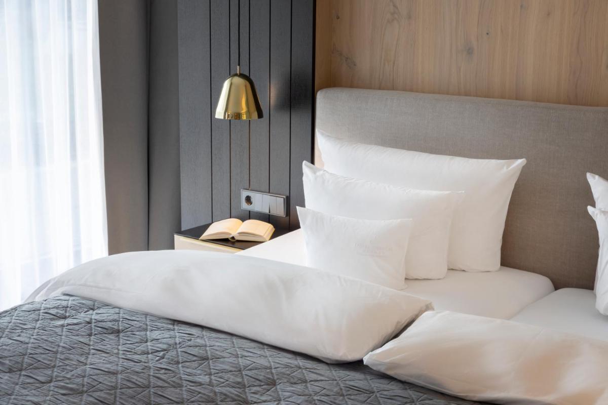 Ein Bett oder Betten in einem Zimmer der Unterkunft Wellness & Genuss Resort - Engel Obertal