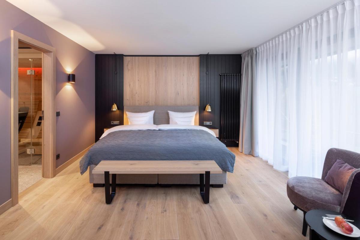 Ein Bett oder Betten in einem Zimmer der Unterkunft Wellness & Genuss Resort - Engel Obertal