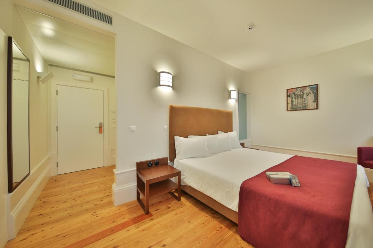 Uma cama ou camas num quarto em Hotel Quinta da Cruz & SPA