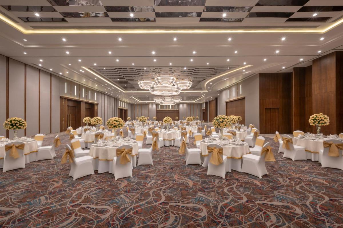 a banquet hall with tables set up for a banquet at Welcomhotel by ITC Hotels, Delhi-Gurugram Highway in New Delhi