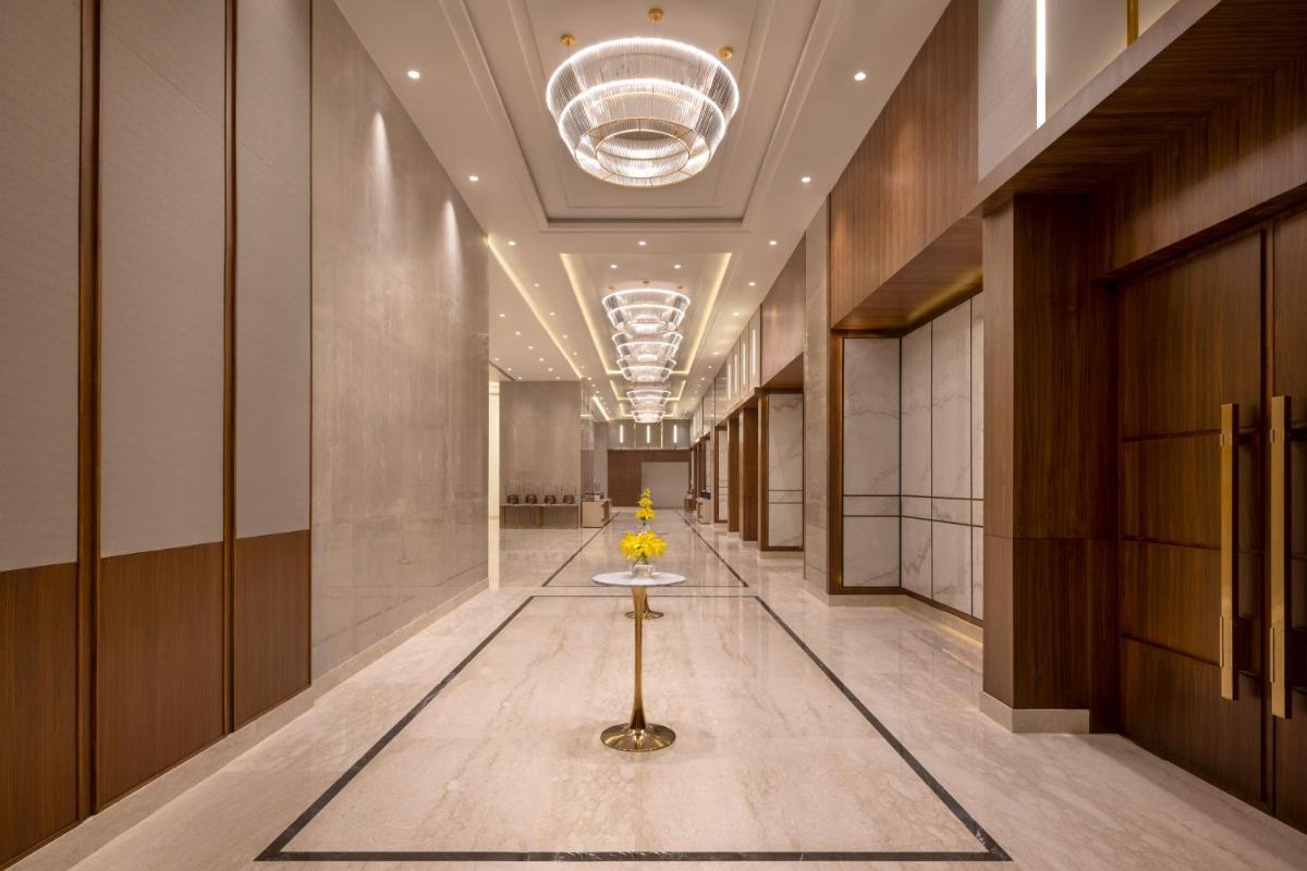 a hallway with a table in the middle of a building at Welcomhotel by ITC Hotels, Delhi-Gurugram Highway in New Delhi