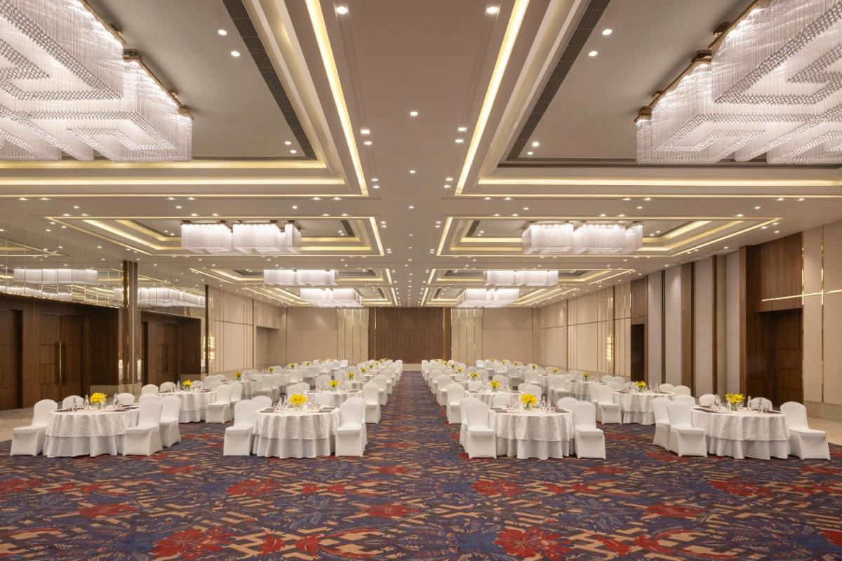 a large banquet hall with white tables and chairs at Welcomhotel by ITC Hotels, Delhi-Gurugram Highway in New Delhi