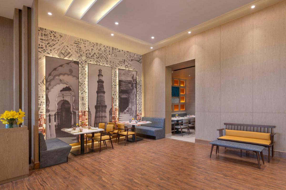 a restaurant with tables and chairs in a room at Welcomhotel by ITC Hotels, Delhi-Gurugram Highway in New Delhi