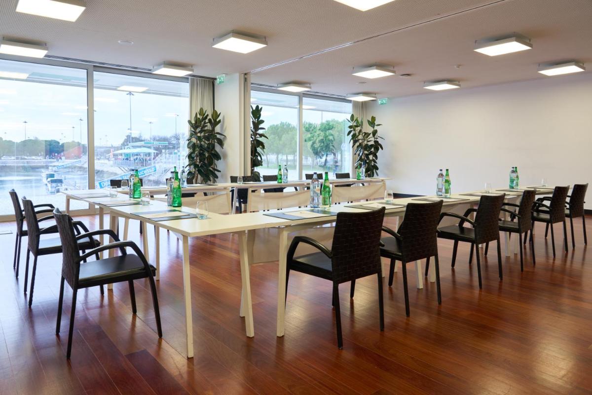 uma grande sala de conferências com uma mesa longa e cadeiras em Altis Belem Hotel & Spa, a Member of Design Hotels em Lisboa mais 32 fotografias