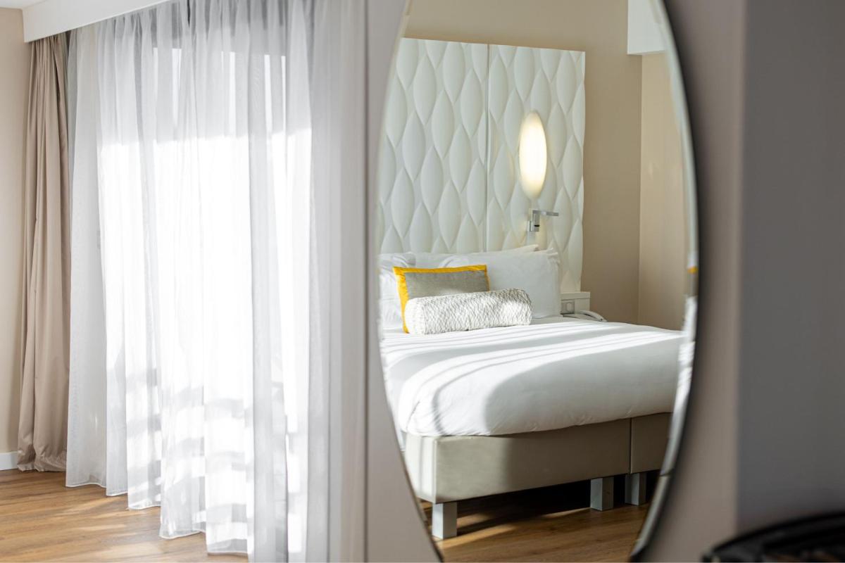 Un ou plusieurs lits dans un hébergement de l'établissement Renaissance Aix-en-Provence Hotel