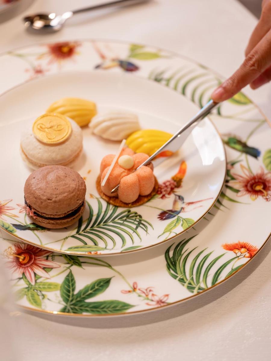 a plate of food with cookies on a table at The Leela Hyderabad Banjara Hills in Hyderabad