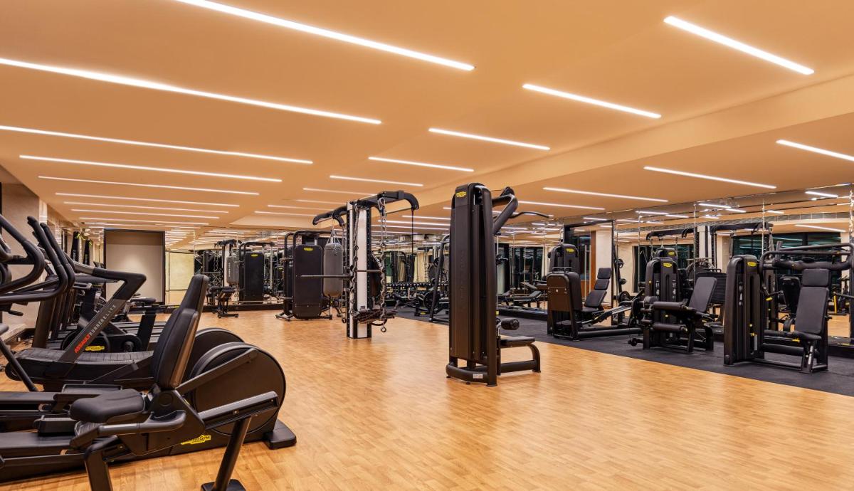a gym with treadmills and elliptical machines at The Leela Hyderabad Banjara Hills in Hyderabad +51 photos