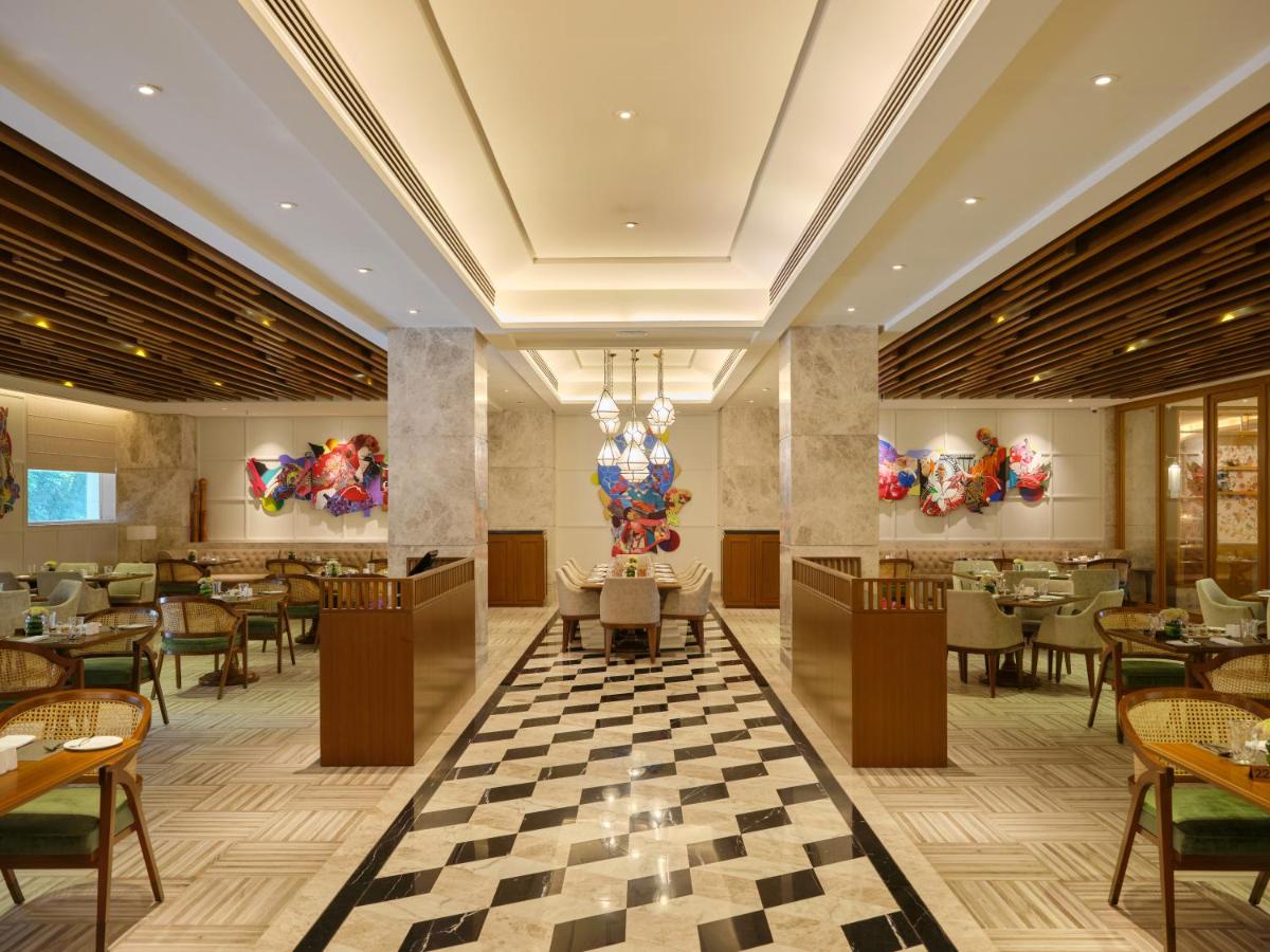 a rendering of a restaurant with tables and chairs at The Leela Hyderabad Banjara Hills in Hyderabad