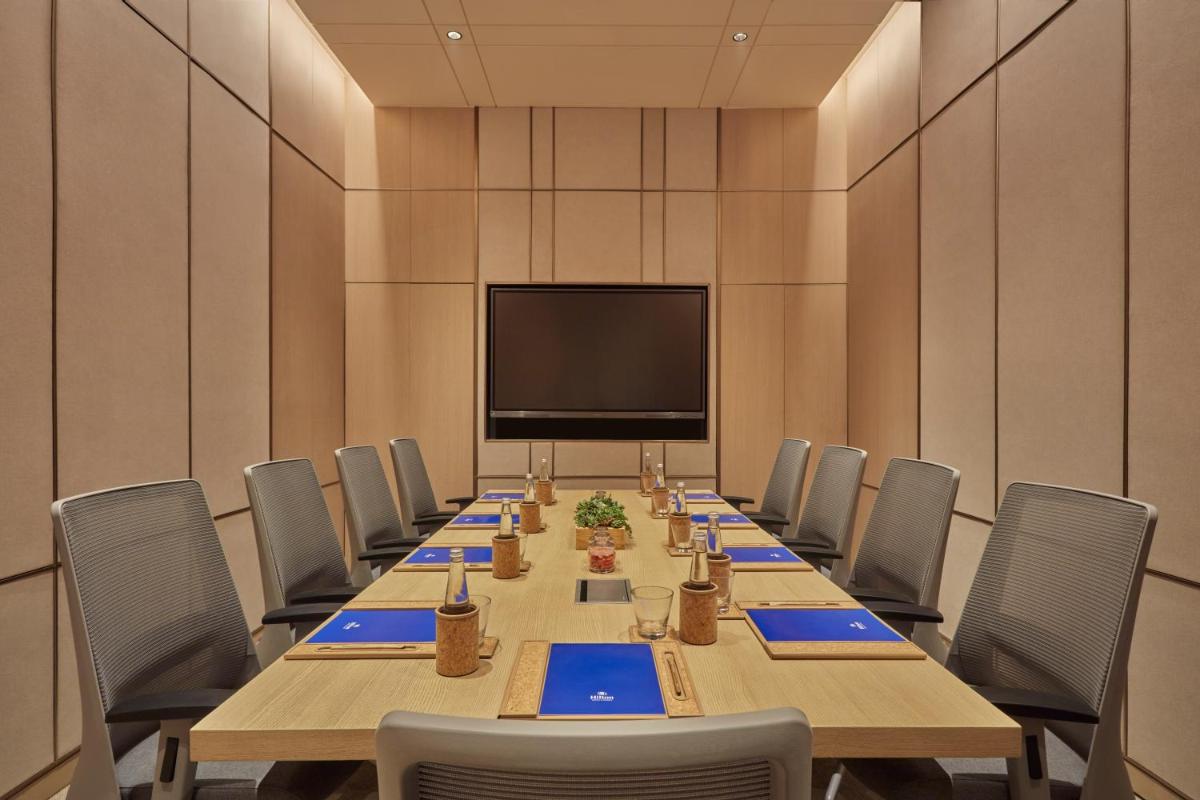 a large conference room with a long table and chairs at Hilton Gurugram Baani City Centre in Gurgaon