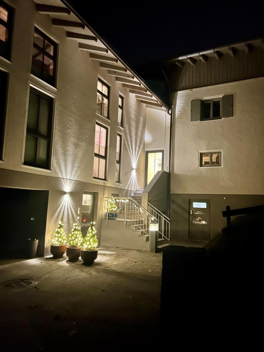 ein Gebäude mit Weihnachtsbäumen davor bei Nacht in der Unterkunft Alpenglühn Apartments - Adult Only in Berchtesgaden