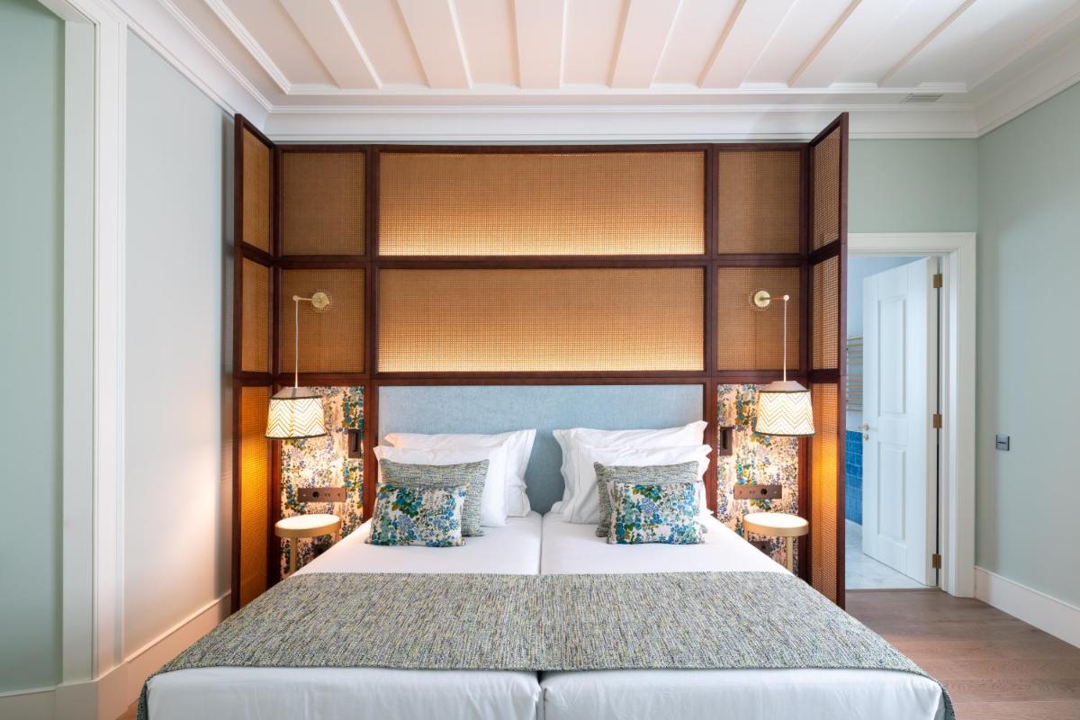 Uma cama ou camas num quarto em Palácio Ludovice Wine Experience Hotel