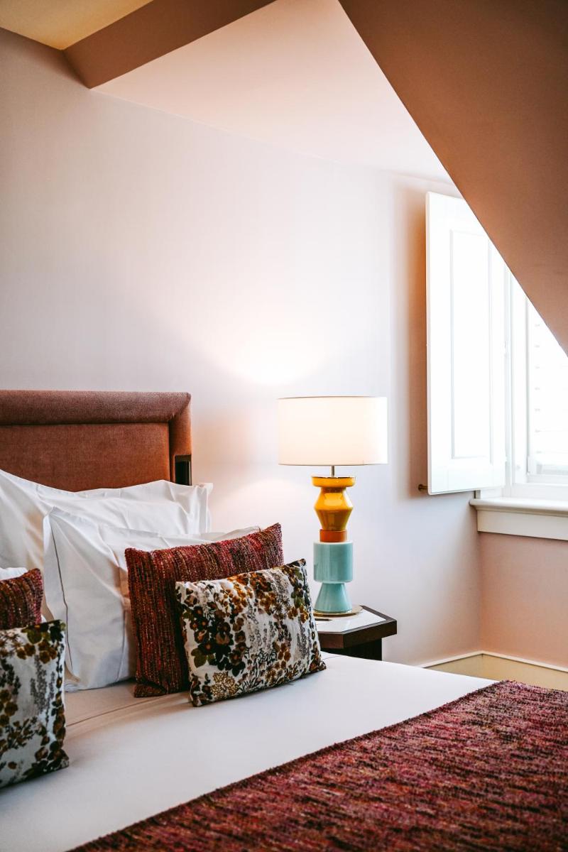 Uma cama ou camas num quarto em Palácio Ludovice Wine Experience Hotel