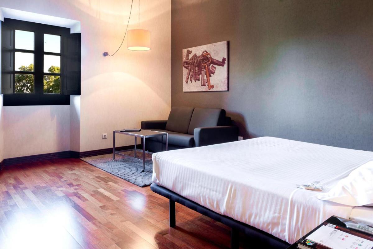 Cama o camas de una habitación en AC Hotel Palacio de Santa Ana by Marriott