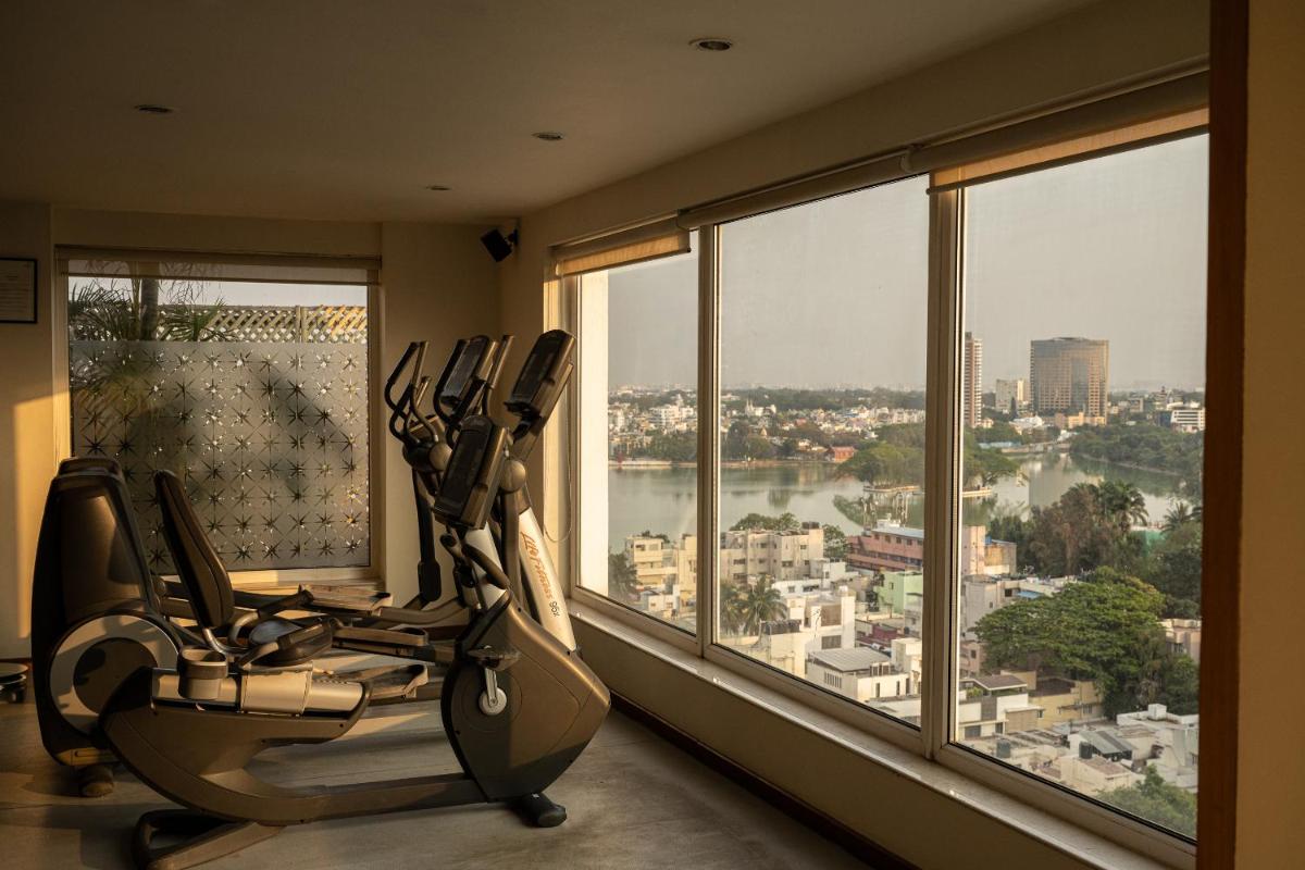 a room with a gym with a view of a city at Lemon Tree Premier, Ulsoor Lake, Bengaluru in Bengaluru