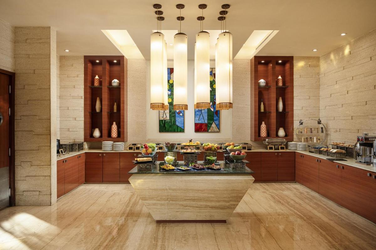 a large kitchen with a island in the middle at Lemon Tree Premier, Ulsoor Lake, Bengaluru in Bengaluru