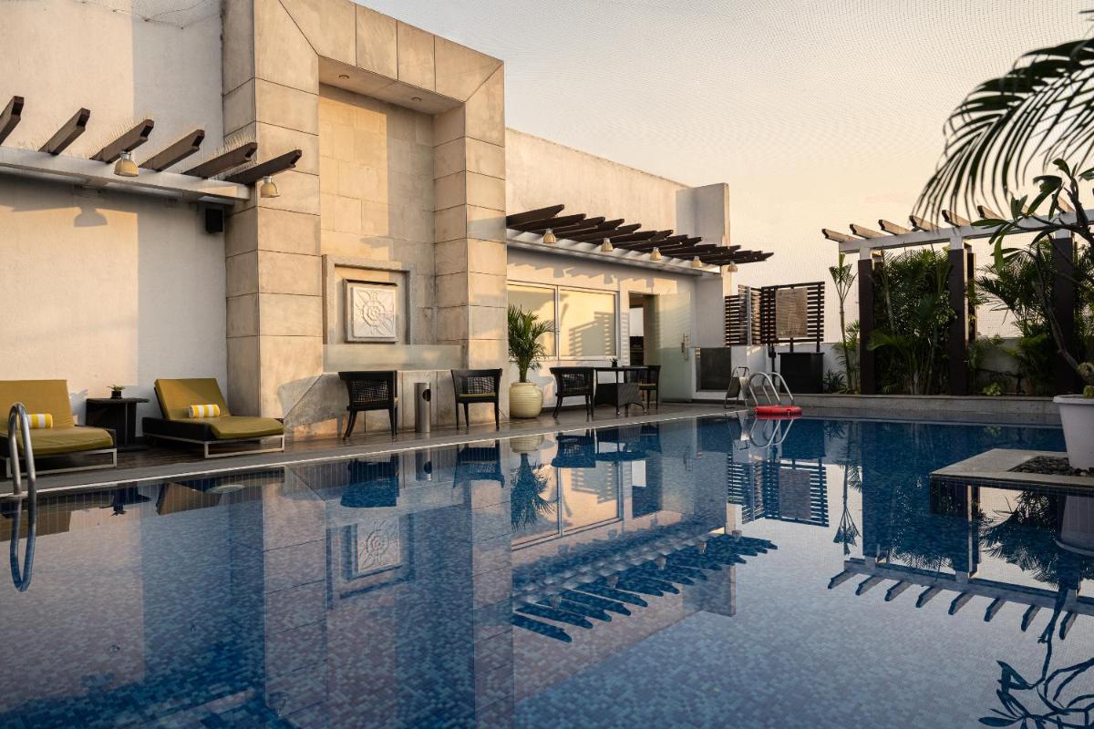 a swimming pool in the middle of a building at Lemon Tree Premier, Ulsoor Lake, Bengaluru in Bengaluru