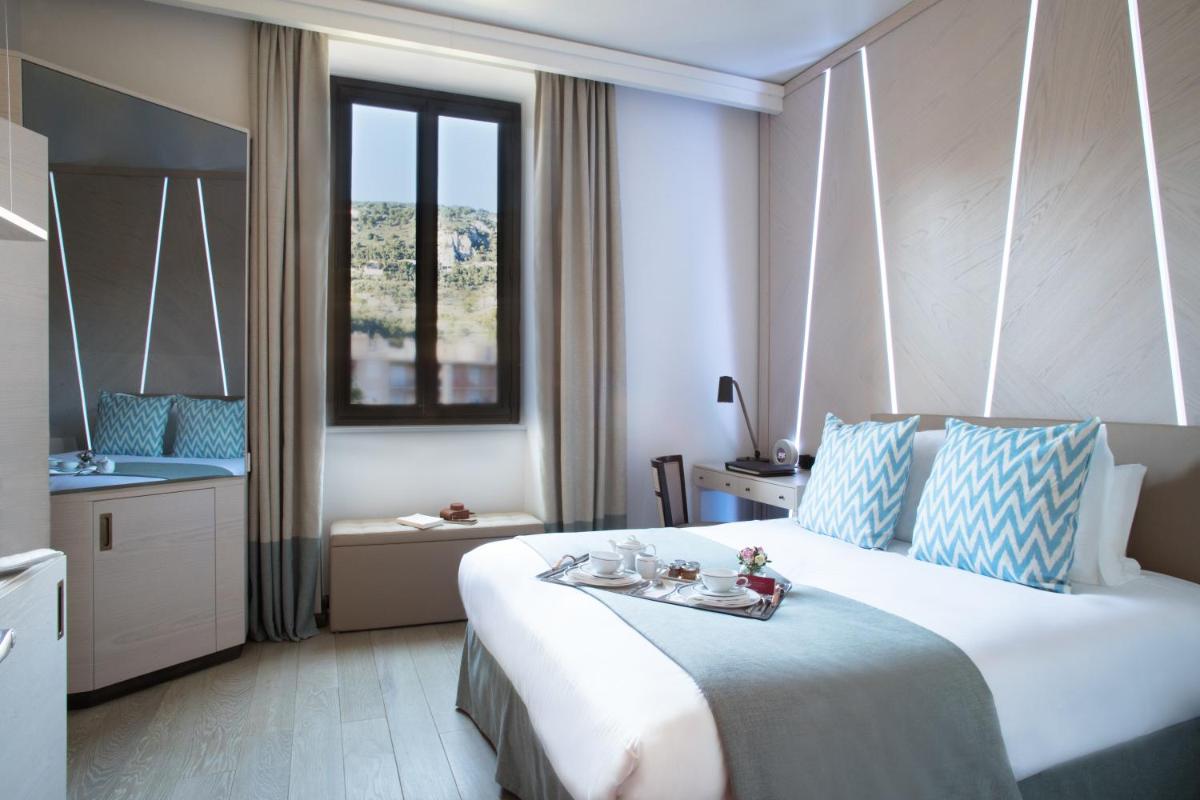Un ou plusieurs lits dans un hébergement de l'établissement Hotel Royal-Riviera