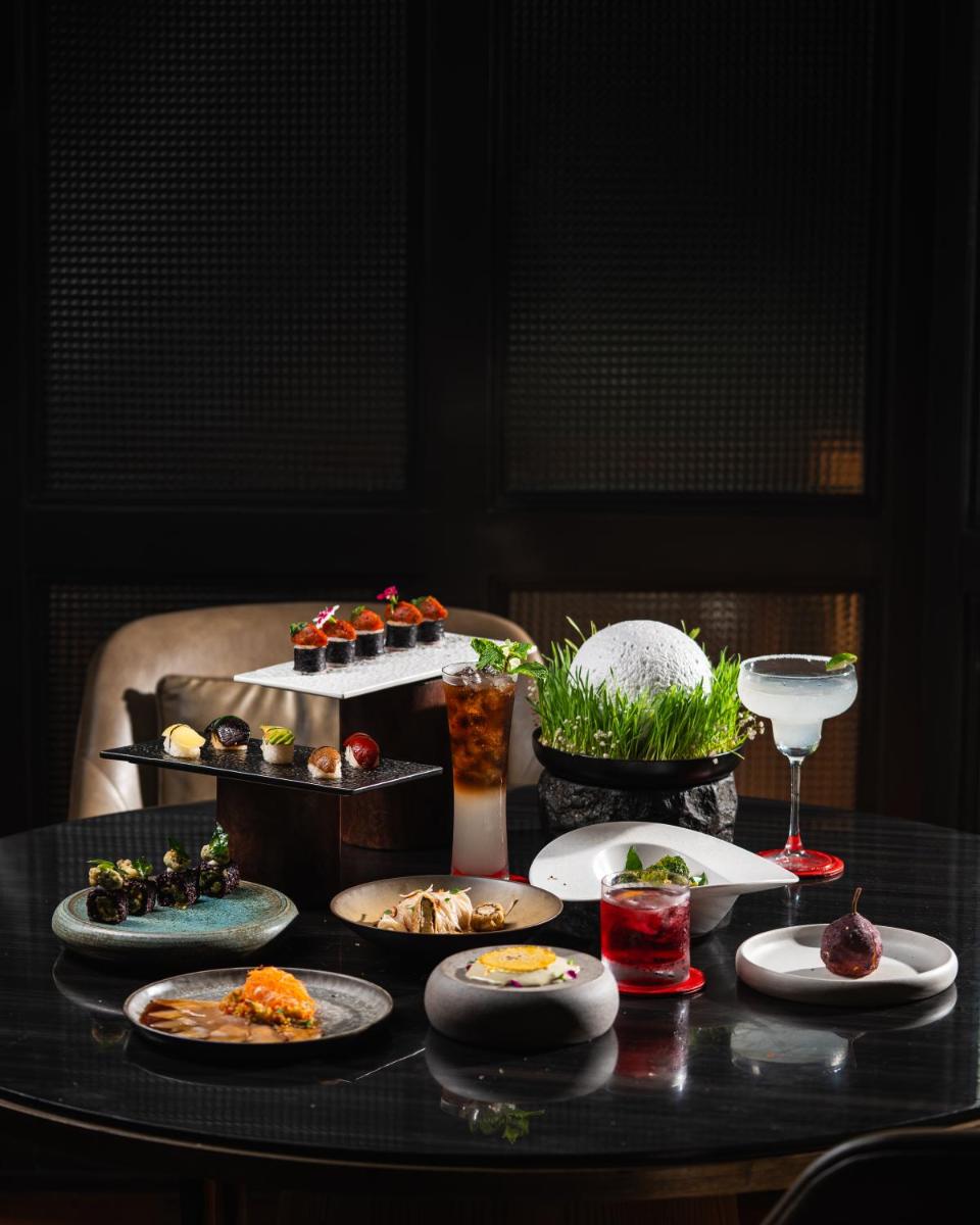 a table with plates of food and drinks on it at JW Marriott Hotel Kolkata in Kolkata