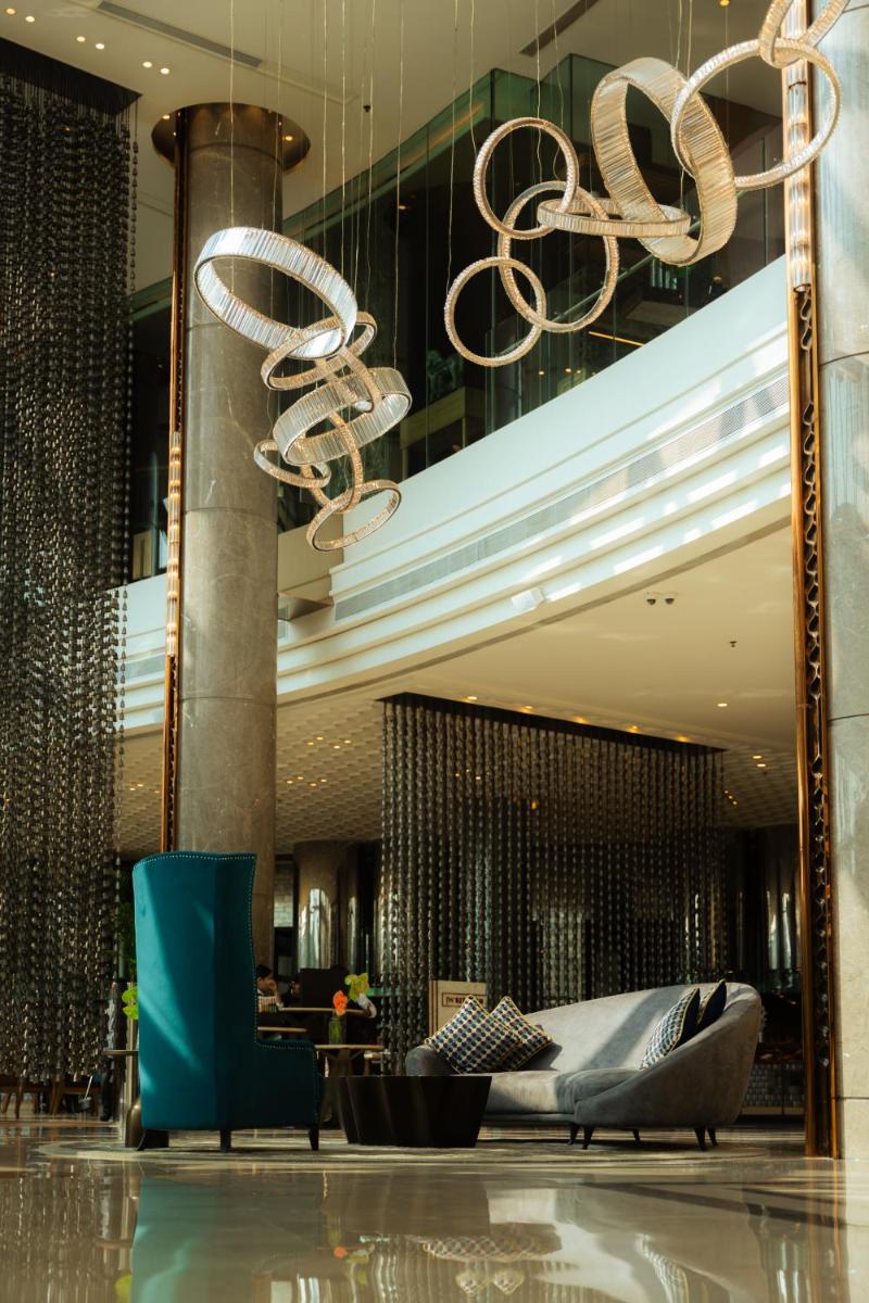 a lobby with a large chandelier in a building at JW Marriott Hotel Kolkata in Kolkata
