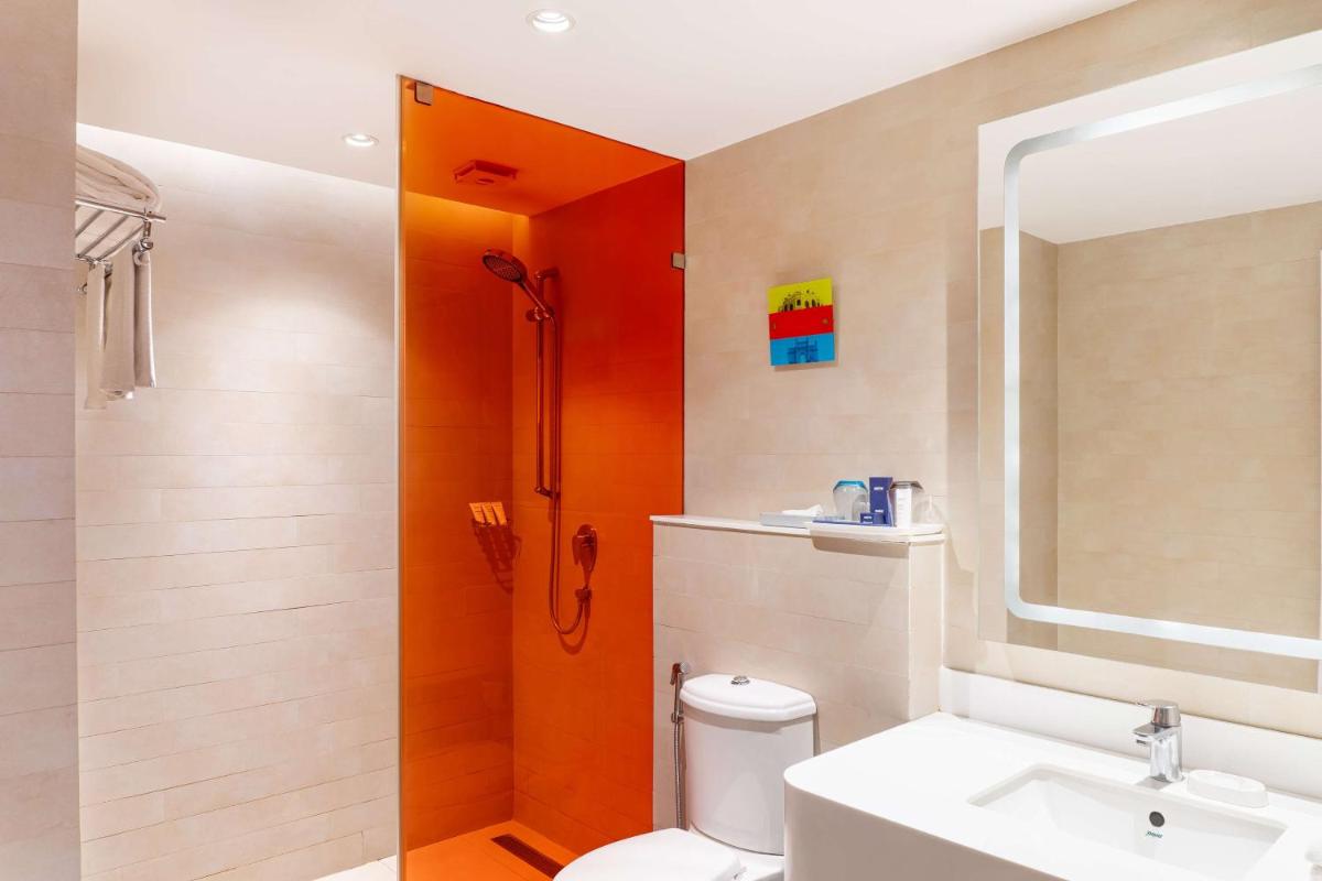 a bathroom with a shower and a toilet and a sink at Park Inn by Radisson,South Delhi in New Delhi a bathroom with a shower and a toilet and a sink at Park Inn by Radisson,South Delhi in New Delhi