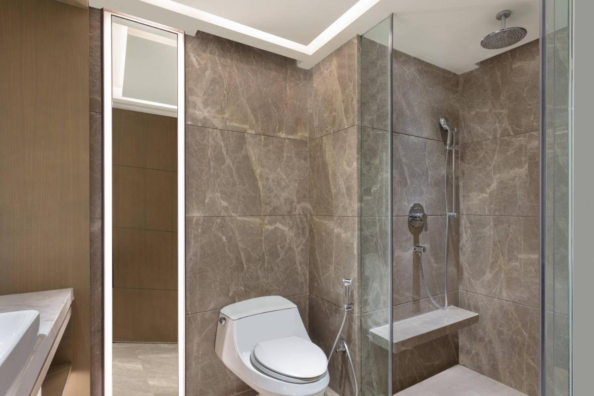 a bathroom with a toilet and a glass shower at Courtyard by Marriott Amritsar in Amritsar