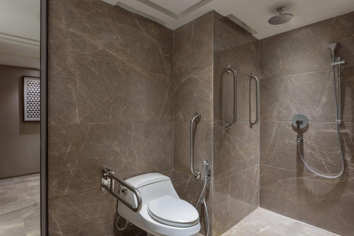 a bathroom with a shower with a toilet in it at Courtyard by Marriott Amritsar in Amritsar