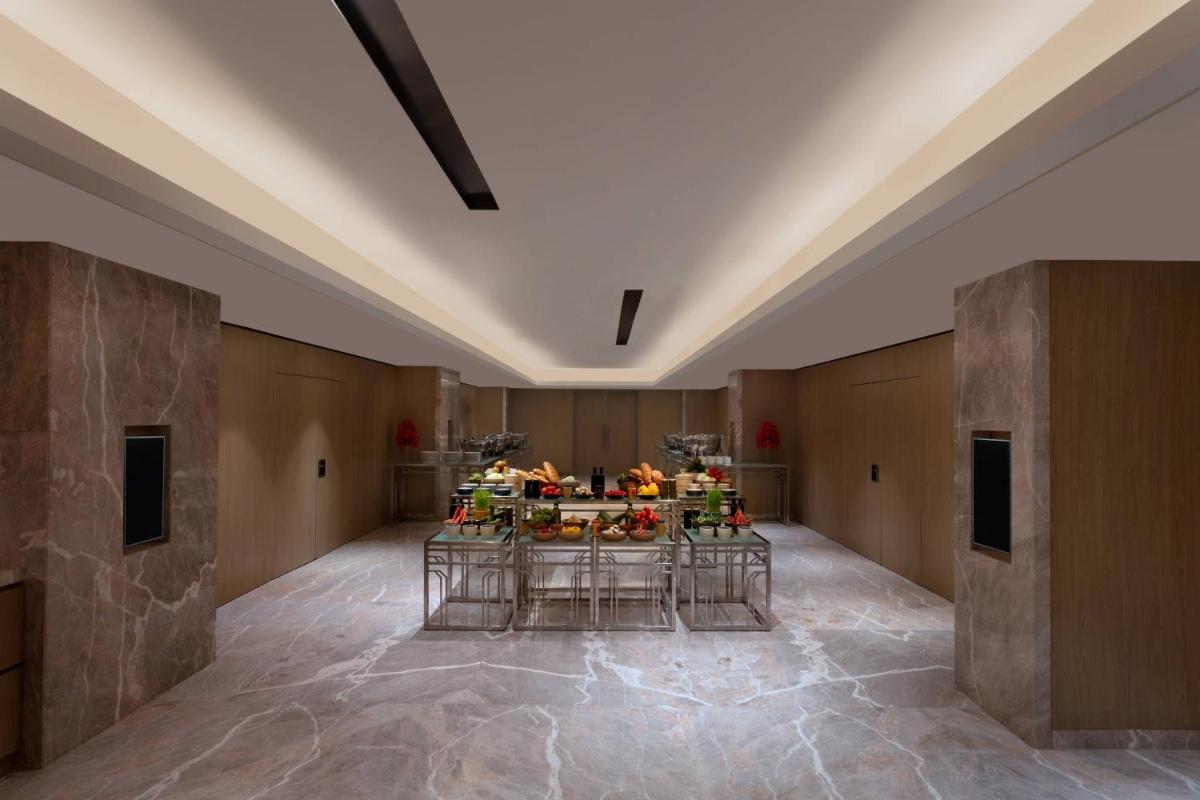 a large room with a table with flowers on it at Courtyard by Marriott Amritsar in Amritsar