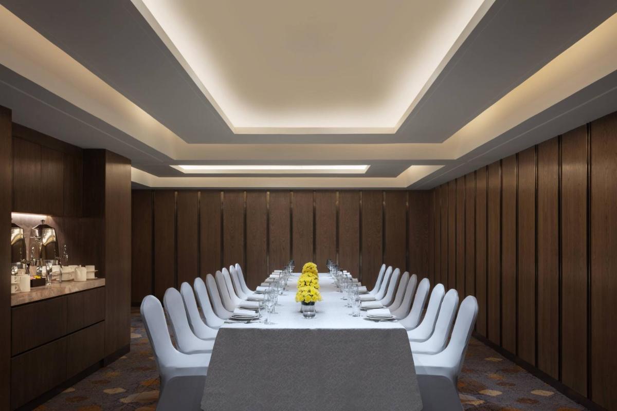 a conference room with a long table and white chairs at Courtyard by Marriott Amritsar in Amritsar
