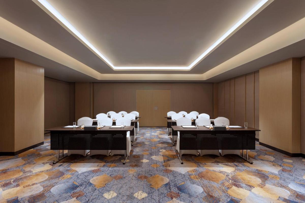 a conference room with white chairs in it at Courtyard by Marriott Amritsar in Amritsar