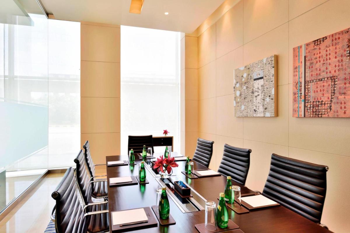 a conference room with a long table and chairs at Courtyard by Marriott Pune Hinjewadi in Pune