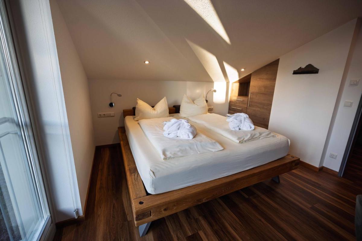 Ein Bett oder Betten in einem Zimmer der Unterkunft Alpenglühn Apartments - Adult Only