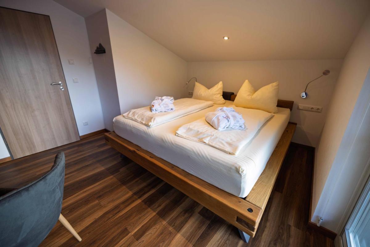 Ein Bett oder Betten in einem Zimmer der Unterkunft Alpenglühn Apartments - Adult Only