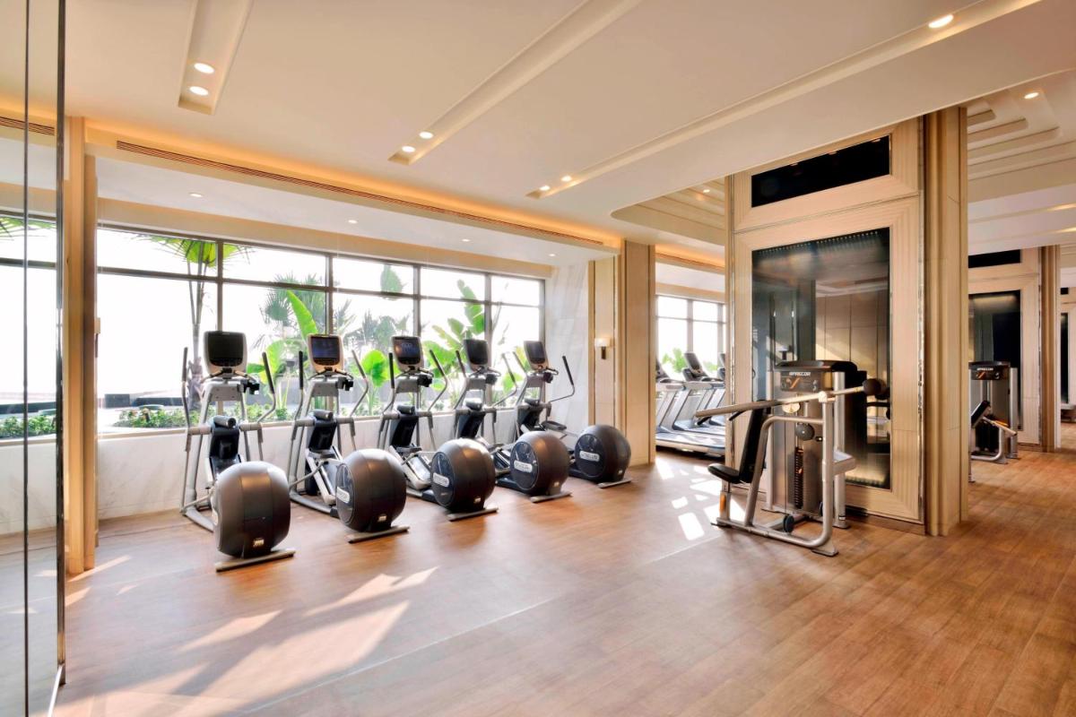 a gym with treadmills and cardio equipment in a building at JW Marriott Hotel Kolkata in Kolkata