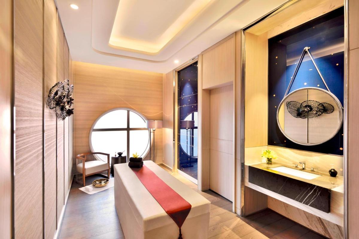 a bathroom with a bench and a sink at JW Marriott Hotel Kolkata in Kolkata